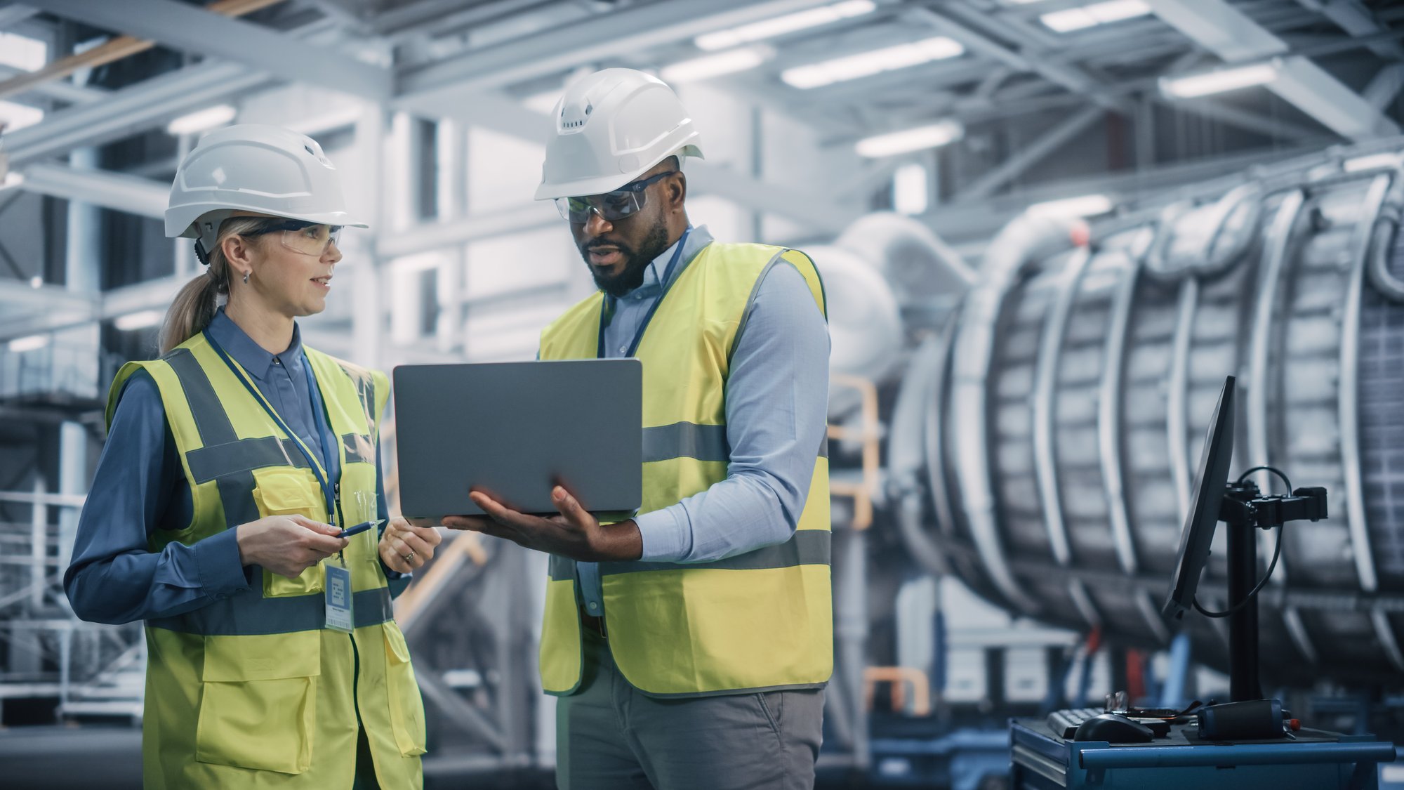 Two people discussing the Parylene coating process.