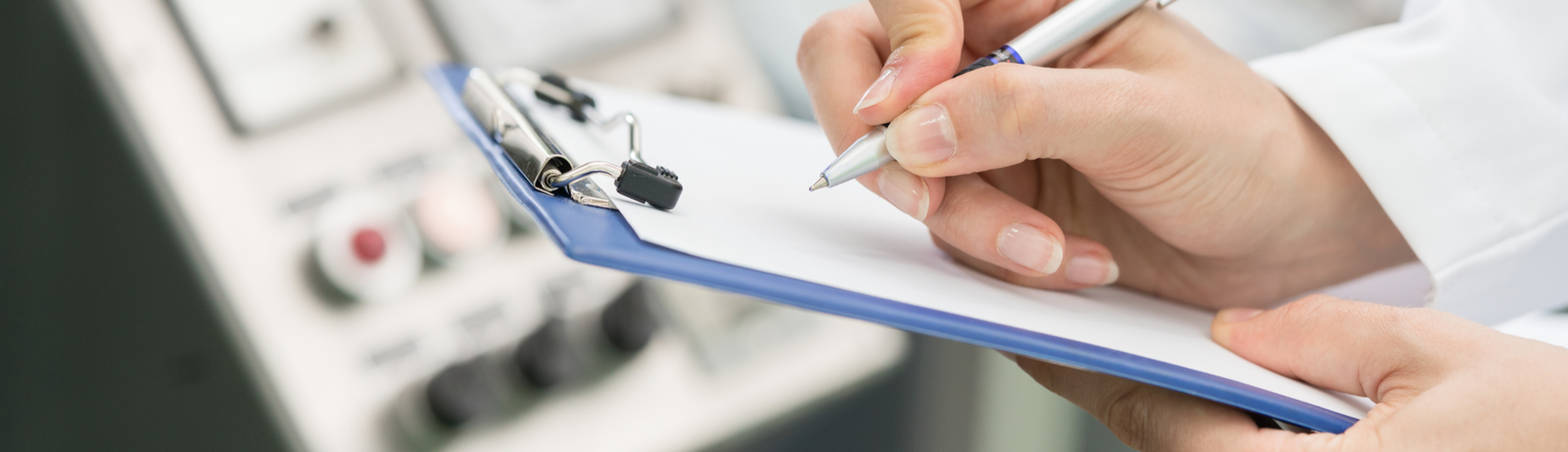man writing on clipboard