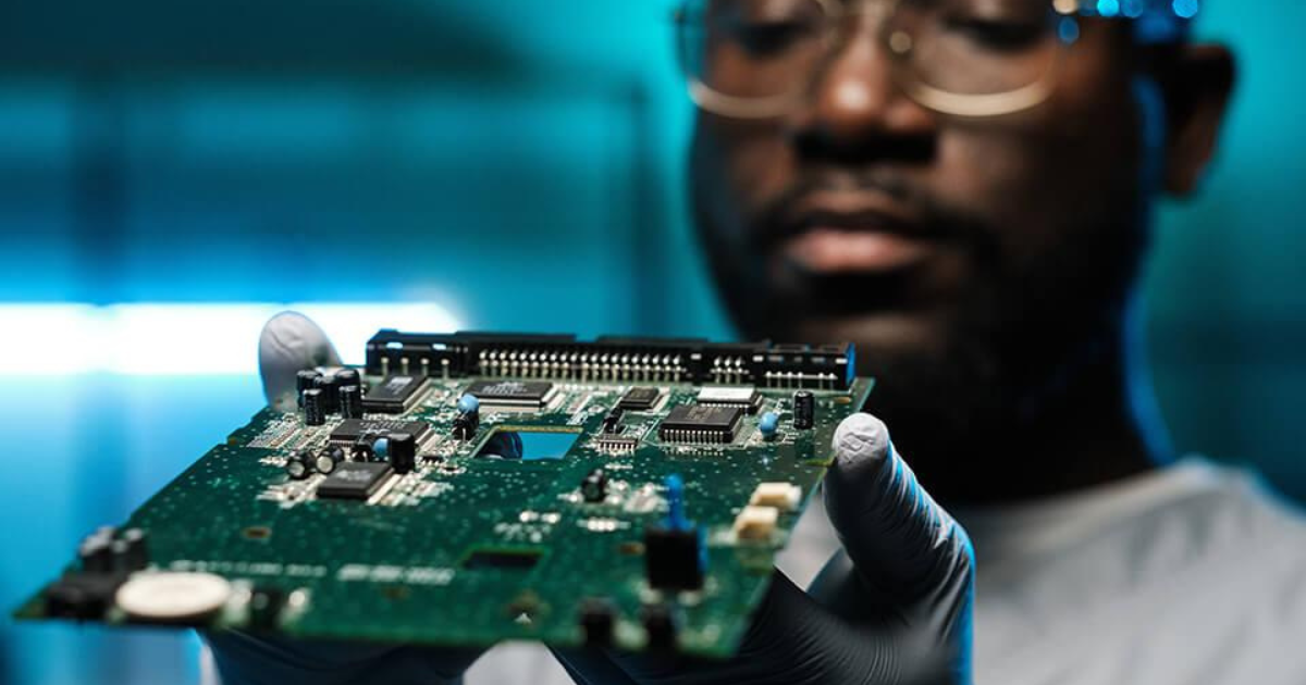 a technician/engineer inspecting or handling a circuit board in a clean, high-tech environment. a technician/engineer inspecting or handling a circuit board in a clean, high-tech environment.